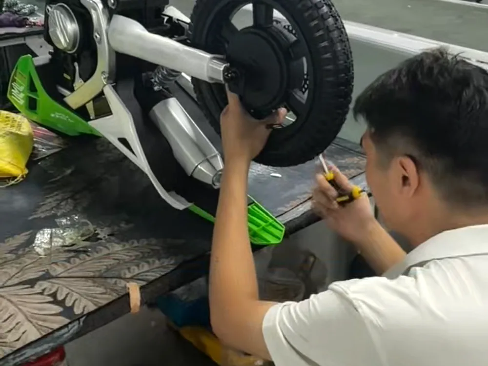 Factory worker assembling a kids ride-on product